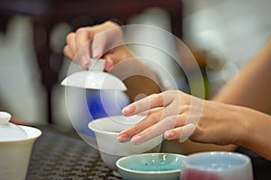 A tea sommelier is making tea for a customer