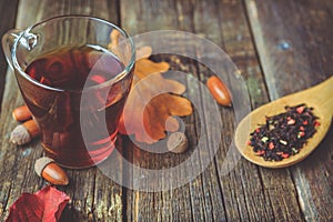 Tea with spices on a wooden background