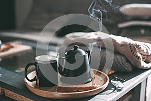 Tea with steam in room in morning sunlight