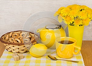 Tea with sugar and lemon, bagels and bouquet