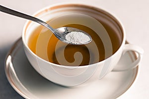 Tea with sweetener in a spoon