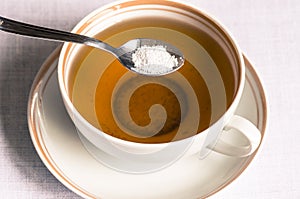 Tea with sweetener in a spoon