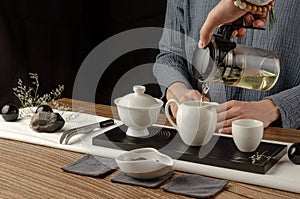 Tea table with instruments teapots cups pancake and tea Shen Puer