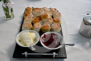 Tea time with british specialities scones jam and clotted cream