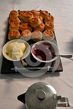 Tea time with british specialities scones jam and clotted cream