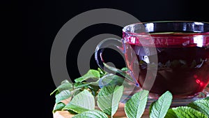Tea time: cup of tea. Creative layout made of cup of hibiscus tea and tea leafs. Red tea, carcade, karkade, rooibos. Oriental,