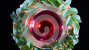 Tea time: cup of tea. Creative layout made of cup of hibiscus tea and tea leafs. Top view. Red tea, carcade, karkade, rooibos.