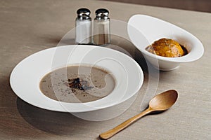 Tea Time Special Truffle Cashew Mushroom Soup with fried ball and salt served in a dish isolated on dark background side view