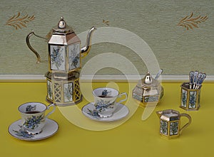 Tea for two, english teacups, saucers, silver-plated teapot on a silver stove, spoon vase and teaspoon, cream jug, sugar bowl