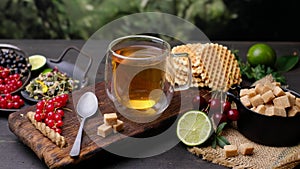 Tea, waffles and brown sugar. Close-up 4k video shooting, dark background.