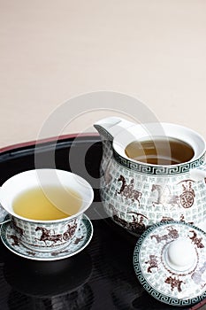 Tea water set for chinese tea style with white cup glass and white teapot on wood backplate