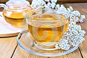 Tea with yarrow in cup on board