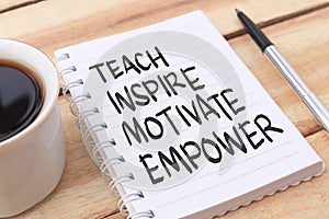 Teach inspire motivate empower, text words typography written on paper against wooden background, life and business motivational