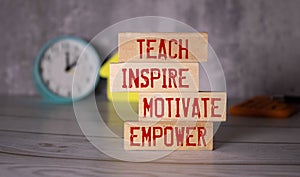 Teach inspire motivate empower, text words on wooden blocks