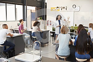 Teacher addressing pupils in a high school science lesson