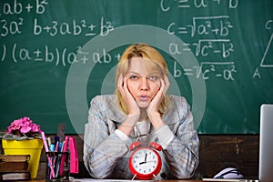 Teacher with alarm clock at blackboard. Time. woman in classroom. Back to school. Teachers day. Study and education