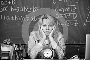 Teacher with alarm clock at blackboard. Time. woman in classroom. Back to school. Teachers day. Study and education