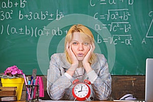 Teacher with alarm clock at blackboard. Time. woman in classroom. Back to school. Teachers day. Study and education