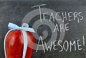 Teacher appreciation image of a red apple tied up with a cute blue ribbon