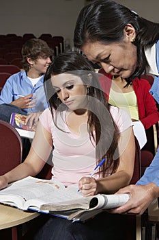 Teacher Assisting Female Student