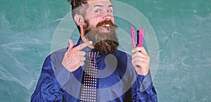 Teacher bearded man with stapler chalkboard background. Prepare for school season buy stationery. Man smiling hold