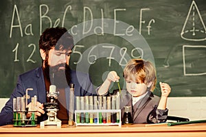 Teacher bearded scientist man child test tubes. Chemical experiment. Genius child private lesson. Knowledge day. Genius