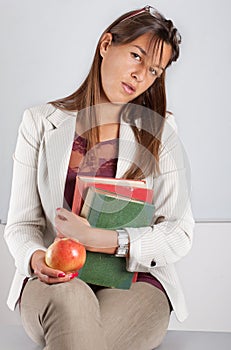 Teacher with books and apple