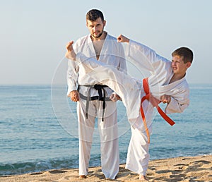 Teacher and boy doing karate poses