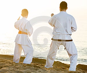 teacher and boy in uniform doing exercises