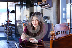 Teacher checking tests in cafe using smartphone