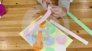 The teacher and the child draw with pencil on paper in art classes. Hands on the table top view. Children`s workshop