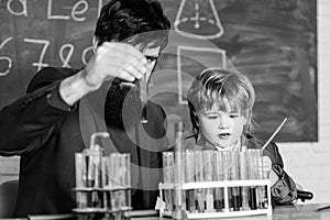 Teacher and child test tubes. School lesson. Perseverance pays off. Chemical experiment. Symptoms of ADHD at school