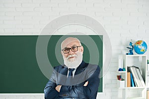 Teacher in the classroom near the blackboard is teaching a lesson. Professor at the university is giving a lecture