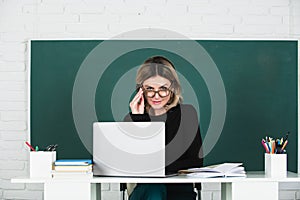 Teacher in classroom at university or college. Female student on board with computer laptop. Lesson seminar skills