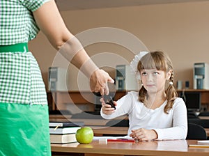 Teacher is confiscating mobile phone at lesson