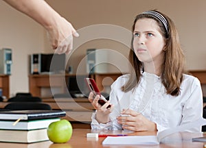 Teacher is confiscating mobile phone at lesson