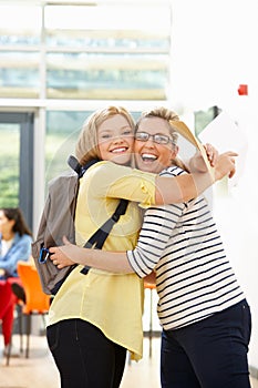 Teacher Congratulating Pupil On Successful Exam Result