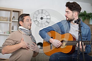 teacher demonstrating breathing exercise to student musician