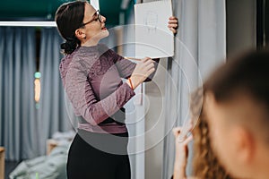 Art teacher explaining drawing techniques in a classroom setting