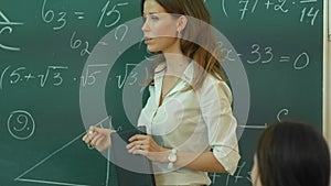 Teacher Doing Math on Chalkboard