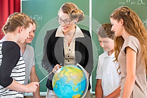 Teacher educate students having geography lessons in school