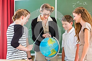 Teacher educate students having geography lessons in school photo