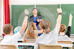 Teacher educate or teaching a class of pupils in school photo