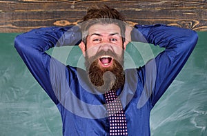 Teacher etiquette tips modern education professional. Man bearded teacher or educator hold head chalkboard background