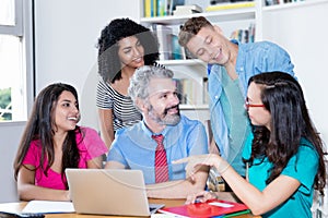 Teacher explainig programming and coding of software to computer science students