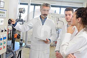 teacher explaining control panel to students