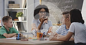 Teacher explaining to pupils in a classroom