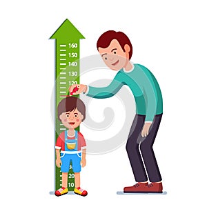 Teacher or father measuring boy kid height