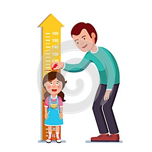 Teacher or father measuring girl kid height