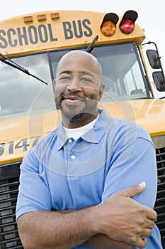 Teacher In Front Of School Bus